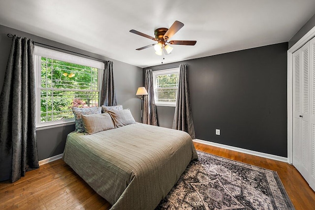 4550 Comanche Dr, Okemos, MI 48864 - bedroom featuring wood finished floors, a ceiling fan, and a closet