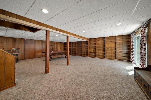 4550 Comanche Dr, Okemos, MI 48864 - basement featuring pool table, wood walls, carpet, a drop ceiling, and built in shelves