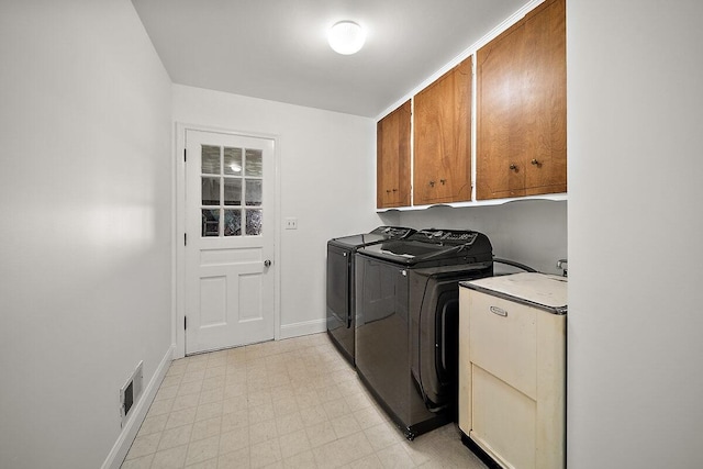 4550 Comanche Dr, Okemos, MI 48864 - laundry area featuring washer and clothes dryer, cabinet space, and light floors