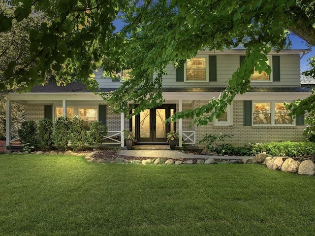 4550 Comanche Dr, Okemos, MI 48864 - view of front of property featuring brick siding, a front yard, and french doors