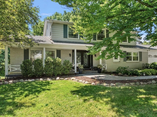 4550 Comanche Dr, Okemos, MI 48864 - view of front of house with brick siding, a front lawn, and a porch