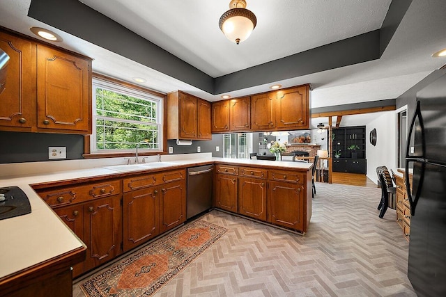 4550 Comanche Dr, Okemos, MI 48864 - kitchen with stainless steel dishwasher, light countertops, freestanding refrigerator, brown cabinets, and recessed lighting