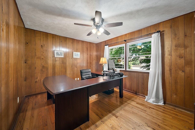 4550 Comanche Dr, Okemos, MI 48864 - office space featuring ceiling fan, light wood-style floors, wooden walls, and a textured ceiling