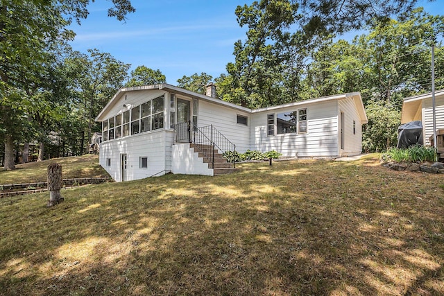 193 S Emerson Dr, Branch, MI 49402 - back of house with a lawn, a sunroom, and a chimney