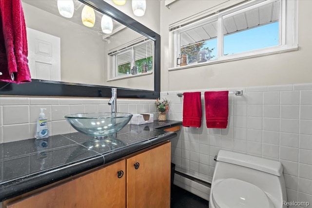 1540 Milford Hills Dr, Milford, MI 48381 - bathroom featuring baseboard heating, vanity, wainscoting, and tile walls