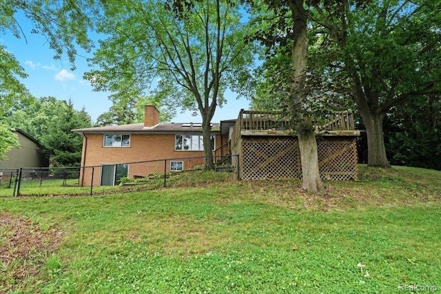 1540 Milford Hills Dr, Milford, MI 48381 - back of property with a chimney, brick siding, and a deck