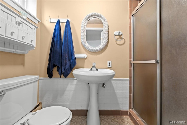 1540 Milford Hills Dr, Milford, MI 48381 - bathroom with a shower stall, tile walls, and a wainscoted wall