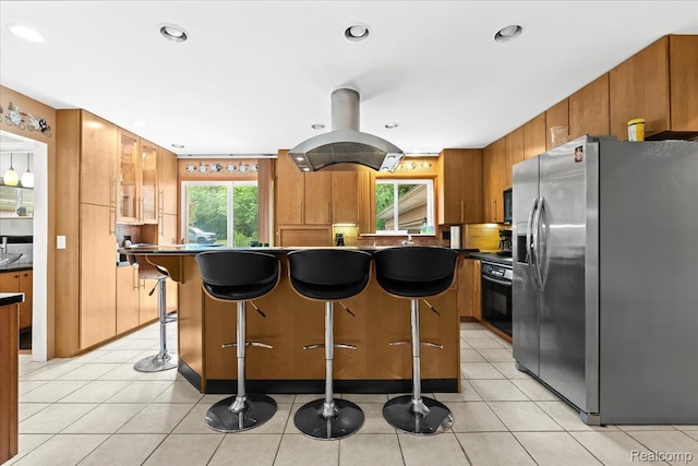 1540 Milford Hills Dr, Milford, MI 48381 - kitchen featuring stainless steel refrigerator with ice dispenser, dark countertops, brown cabinetry, recessed lighting, and a kitchen bar
