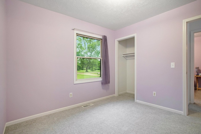 3128 Maurer Rd, Charlotte, MI 48813 - unfurnished bedroom featuring carpet floors, a textured ceiling, and a closet