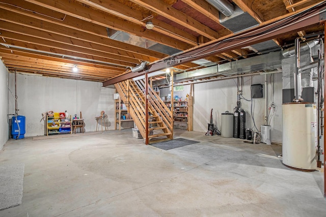 3128 Maurer Rd, Charlotte, MI 48813 - unfinished basement with gas water heater, stairway, a water softener, and a water pressure tank