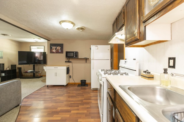 1620 Ontario Rd, Niles, MI 49120 - kitchen with white appliances, dark wood-style floors, light countertops, under cabinet range hood, and a textured ceiling