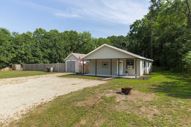 1620 Ontario Rd, Niles, MI 49120 - view of front facade with an outdoor fire pit, driveway, a porch, and a storage shed