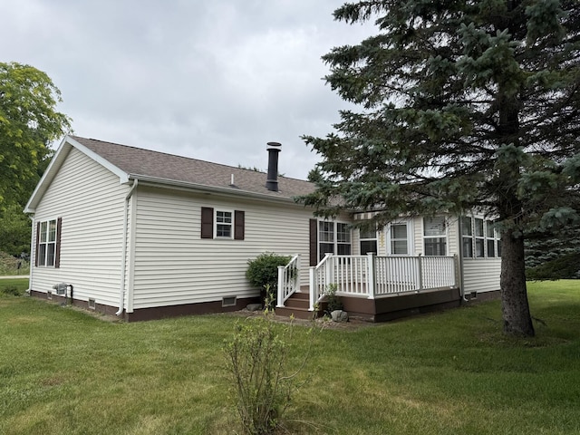 7826 Sunset Shores Dr Unit 43, Canadian Lakes, MI 49346 - rear view of house featuring a wooden deck, a lawn, crawl space, and roof with shingles