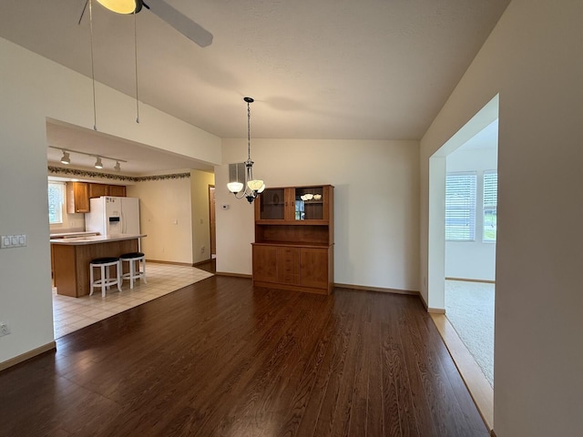 7826 Sunset Shores Dr Unit 43, Canadian Lakes, MI 49346 - unfurnished living room with wood finished floors, a chandelier, ceiling fan, and rail lighting