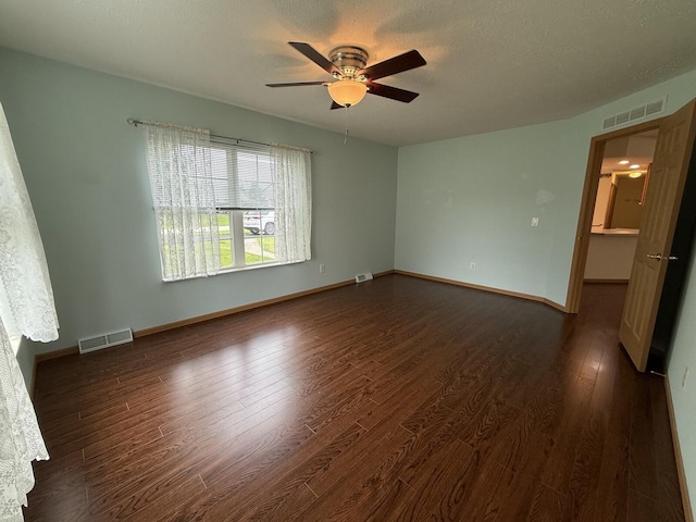 7826 Sunset Shores Dr Unit 43, Canadian Lakes, MI 49346 - spare room featuring dark wood finished floors, a ceiling fan, and a textured ceiling