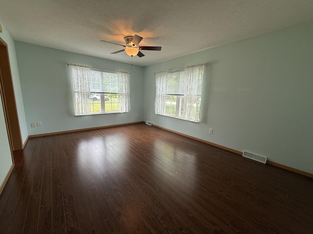 7826 Sunset Shores Dr Unit 43, Canadian Lakes, MI 49346 - spare room featuring dark wood-type flooring, a ceiling fan, and a textured ceiling