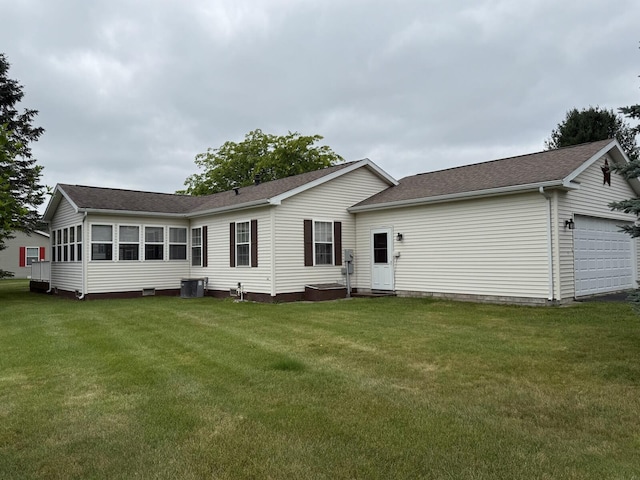 7826 Sunset Shores Dr Unit 43, Canadian Lakes, MI 49346 - rear view of property with a shingled roof, a lawn, and an attached garage