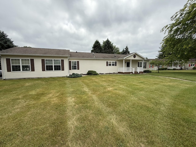 7826 Sunset Shores Dr Unit 43, Canadian Lakes, MI 49346 - view of front of property with a front yard and roof with shingles