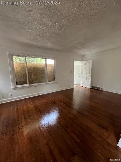15475 Prest St, Detroit, MI 48227 - unfurnished room with hardwood / wood-style floors and a textured ceiling