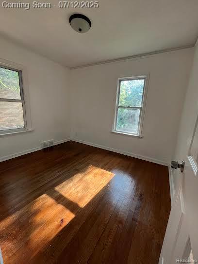 15475 Prest St, Detroit, MI 48227 - unfurnished room featuring plenty of natural light and dark wood finished floors
