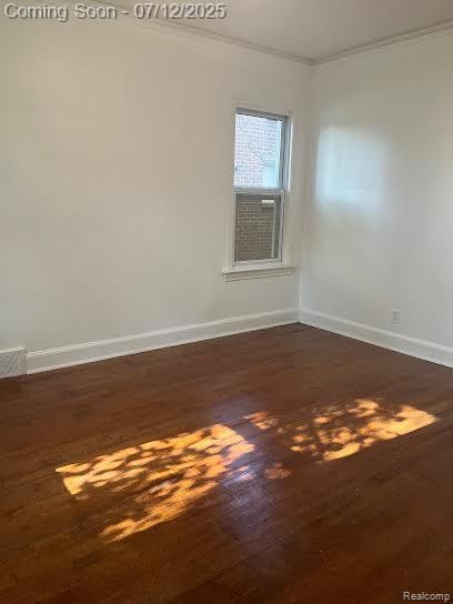 15475 Prest St, Detroit, MI 48227 - spare room featuring ornamental molding and dark wood-style flooring