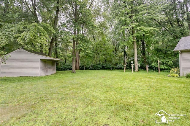 5237 Emerson Dr, Ottawa Lake, MI 49267 - view of grassy yard with an outdoor structure
