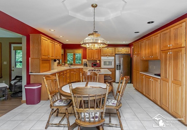 5237 Emerson Dr, Ottawa Lake, MI 49267 - kitchen with white oven, stainless steel fridge, light countertops, a chandelier, and recessed lighting