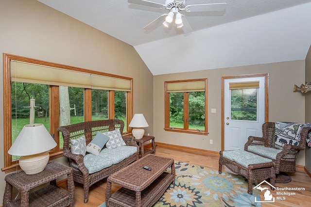 5237 Emerson Dr, Ottawa Lake, MI 49267 - living area with vaulted ceiling, plenty of natural light, light wood-style flooring, and a ceiling fan