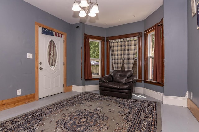 1228 Wells Pl, Kalamazoo, MI 49001 - entryway featuring a chandelier and concrete floors