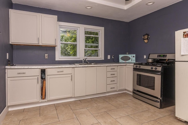 1228 Wells Pl, Kalamazoo, MI 49001 - kitchen with white appliances, white cabinets, light countertops, recessed lighting, and light tile patterned floors