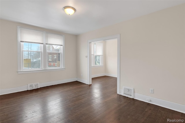 8451 Navy St, Detroit, MI 48209 - spare room featuring dark wood-type flooring and baseboards