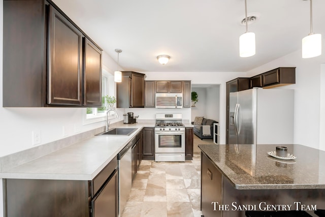 568 N River Hills Dr, Newaygo, MI 49337 - kitchen featuring stainless steel appliances, dark brown cabinets, and decorative light fixtures