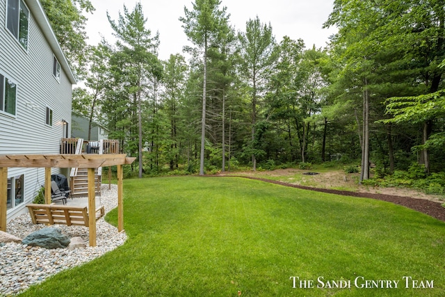 568 N River Hills Dr, Newaygo, MI 49337 - view of green lawn with a wooden deck and stairs