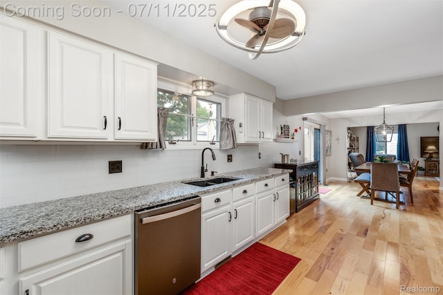 2661 Nottingham, Waterford, MI 48329 - kitchen featuring dishwasher, decorative backsplash, ceiling fan, white cabinets, and plenty of natural light