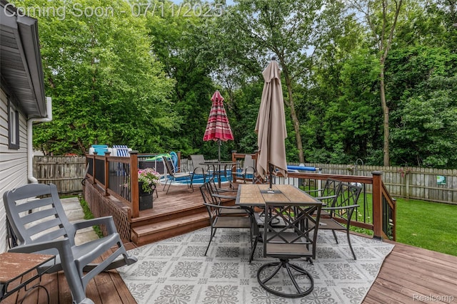 2661 Nottingham, Waterford, MI 48329 - wooden deck featuring outdoor dining space, a fenced backyard, and view of wooded area