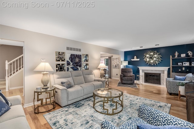 2661 Nottingham, Waterford, MI 48329 - living area featuring wood finished floors, a fireplace, and stairway