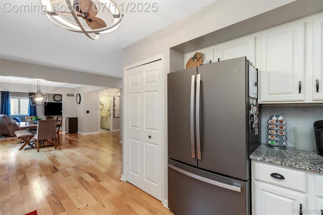 2661 Nottingham, Waterford, MI 48329 - kitchen with freestanding refrigerator, white cabinetry, light wood-style flooring, and open floor plan