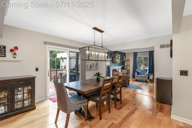 2661 Nottingham, Waterford, MI 48329 - dining area with plenty of natural light, light wood-style floors, and a chandelier
