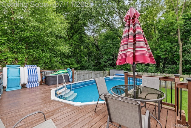 2661 Nottingham, Waterford, MI 48329 - view of pool with a wooden deck, a fenced backyard, outdoor dining area, and view of wooded area