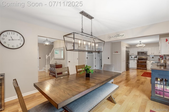 2661 Nottingham, Waterford, MI 48329 - dining area with stairway, light wood-type flooring, a chandelier, and beverage cooler