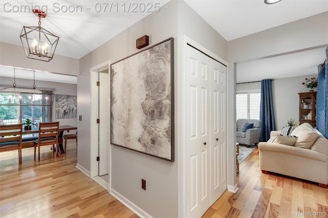 2661 Nottingham, Waterford, MI 48329 - corridor featuring a chandelier and light wood-type flooring