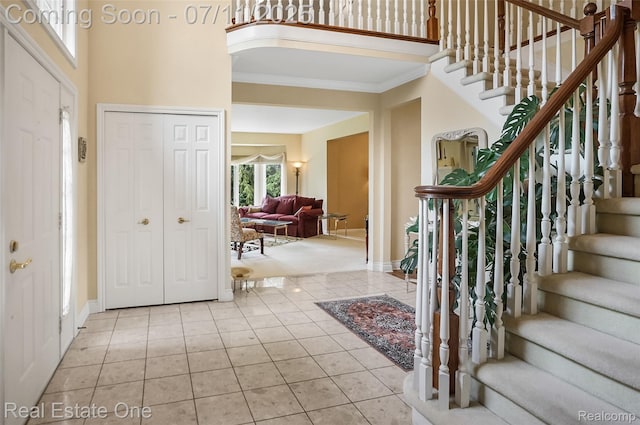 3565 Heron Ridge Dr, Rochester Hills, MI 48309 - foyer entrance with tile patterned floors, ornamental molding, stairs, and a high ceiling