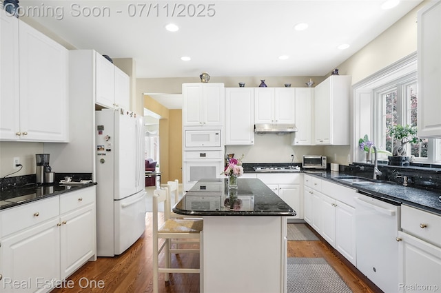 3565 Heron Ridge Dr, Rochester Hills, MI 48309 - kitchen featuring white appliances, under cabinet range hood, dark wood-style flooring, white cabinets, and recessed lighting