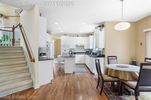 3565 Heron Ridge Dr, Rochester Hills, MI 48309 - dining room featuring stairs, wood finished floors, and recessed lighting