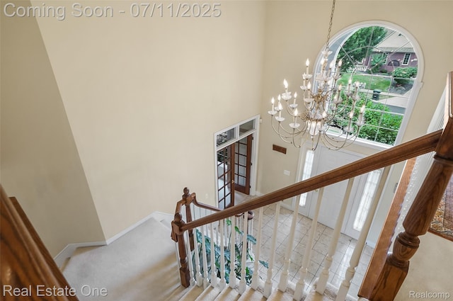 3565 Heron Ridge Dr, Rochester Hills, MI 48309 - staircase featuring a towering ceiling, a chandelier, and carpet floors