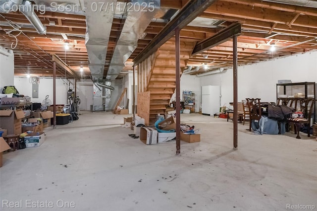3565 Heron Ridge Dr, Rochester Hills, MI 48309 - unfinished below grade area with freestanding refrigerator, stairway, electric panel, and heating unit