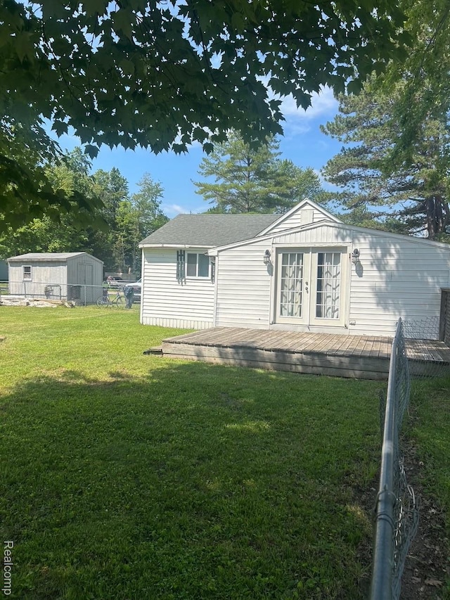 1023 Lakewood Dr, East Tawas, MI 48730 - back of house with a deck and french doors