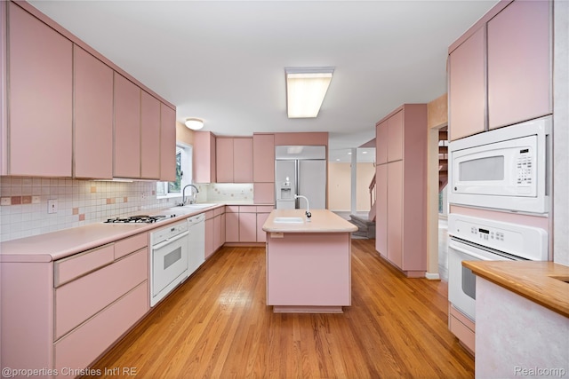 4724 Tara Ct, West Bloomfield, MI 48323 - kitchen featuring built in appliances, light wood finished floors, light countertops, and tasteful backsplash