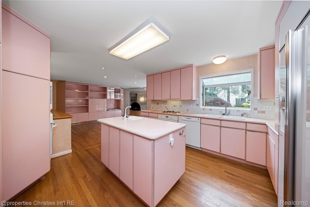 4724 Tara Ct, West Bloomfield, MI 48323 - kitchen with white dishwasher, light countertops, light wood-type flooring, decorative backsplash, and recessed lighting