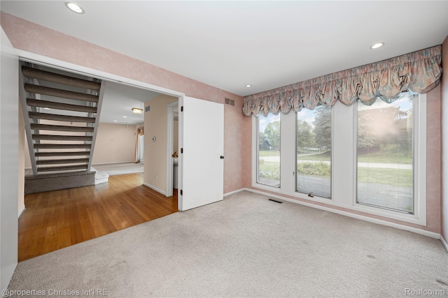 4724 Tara Ct, West Bloomfield, MI 48323 - spare room featuring carpet floors, recessed lighting, wood finished floors, and stairway